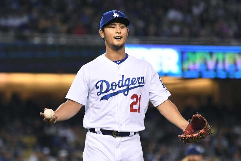 Los Angeles Dodgers pitcher Yu Darvish questions a call by first base umpire Roberto Ortiz...