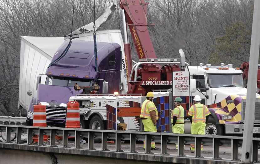 
It took about 24 hours, but the dangling truck finally was pulled off the guardrail Tuesday...