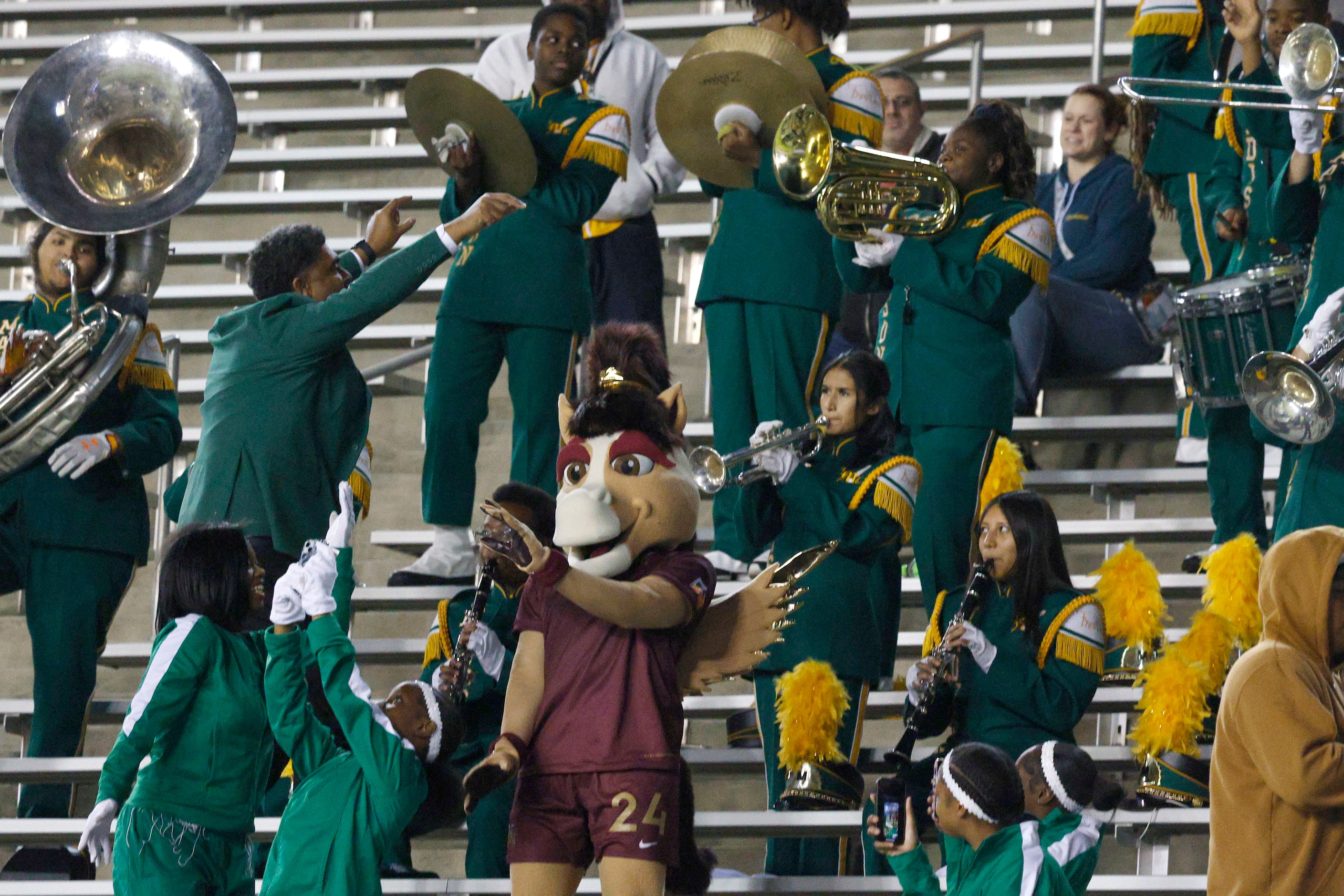 Dallas Trinity FC mascot Boots performs with Madison High School marching band during the...