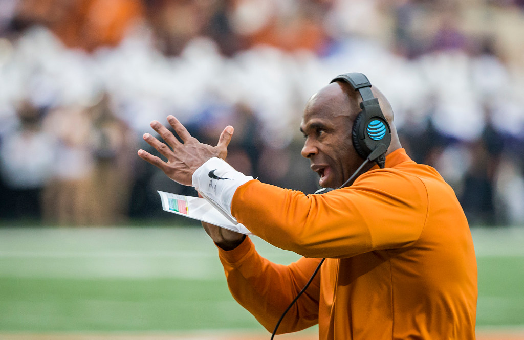 Texas head coach Charlie Strong calls for a timeout during the first half of an NCAA...