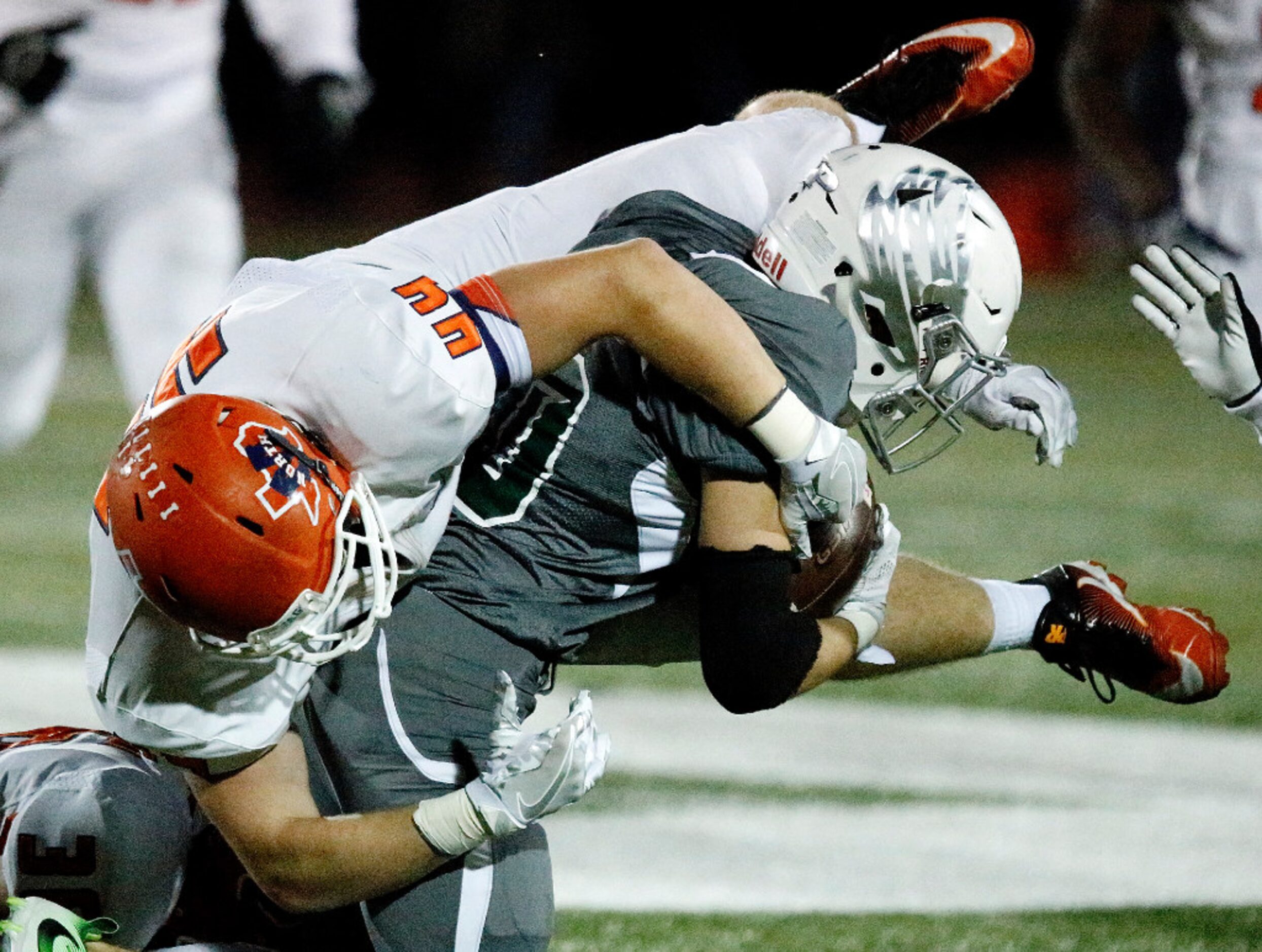 McKinney North High School linebacker Austin Redwine (44) goes horizontal trying to bring...