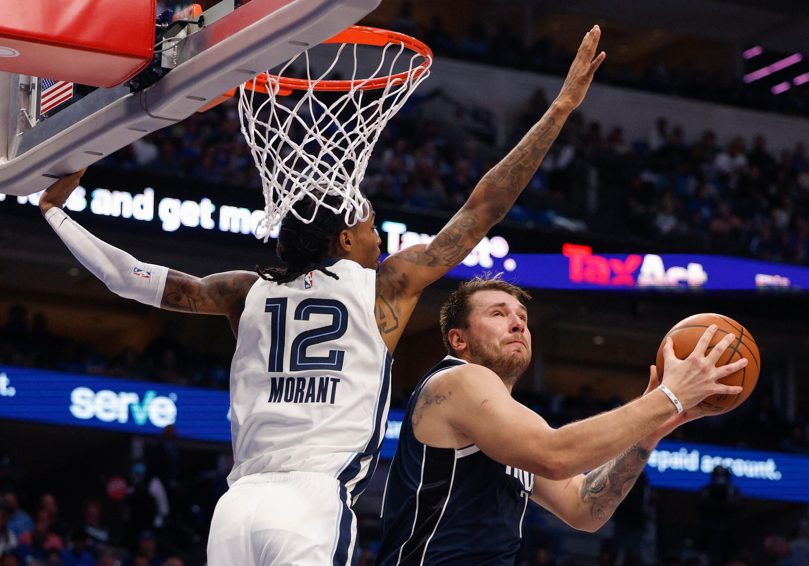 Dallas Mavericks guard Luka Doncic (77) attempts a layup against Memphis Grizzlies guard Ja...