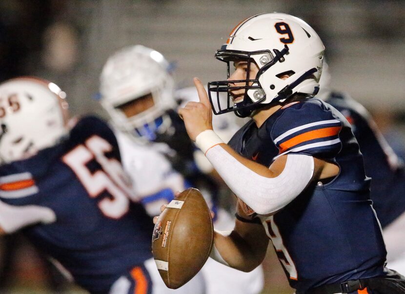 Wakeland High School quarterback Brennan Myer (9) signals his receiver on the run during the...