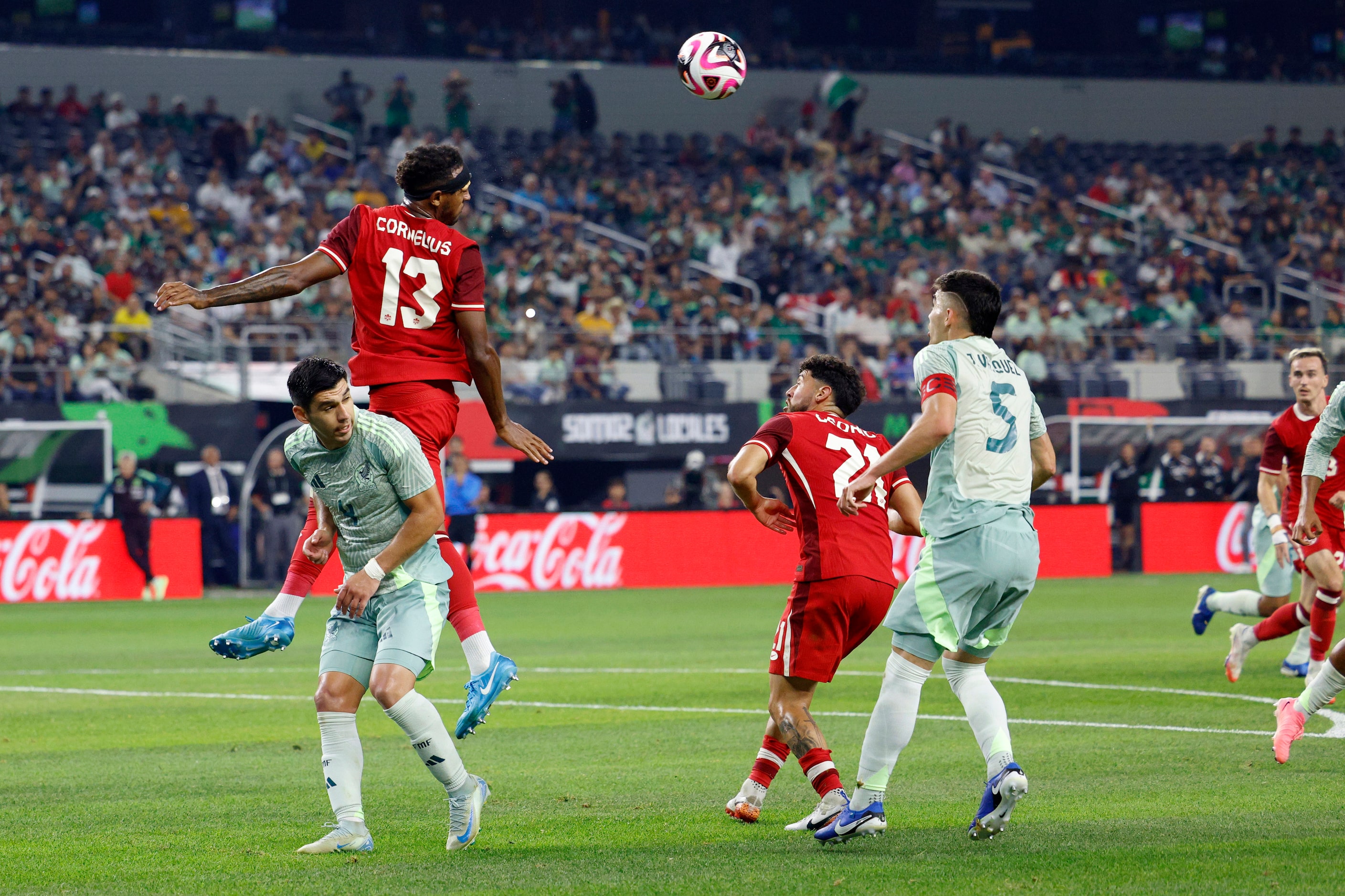 Canada defenseman Derek Cornelius (13) heads the ball away from Mexico defenseman Jesus...