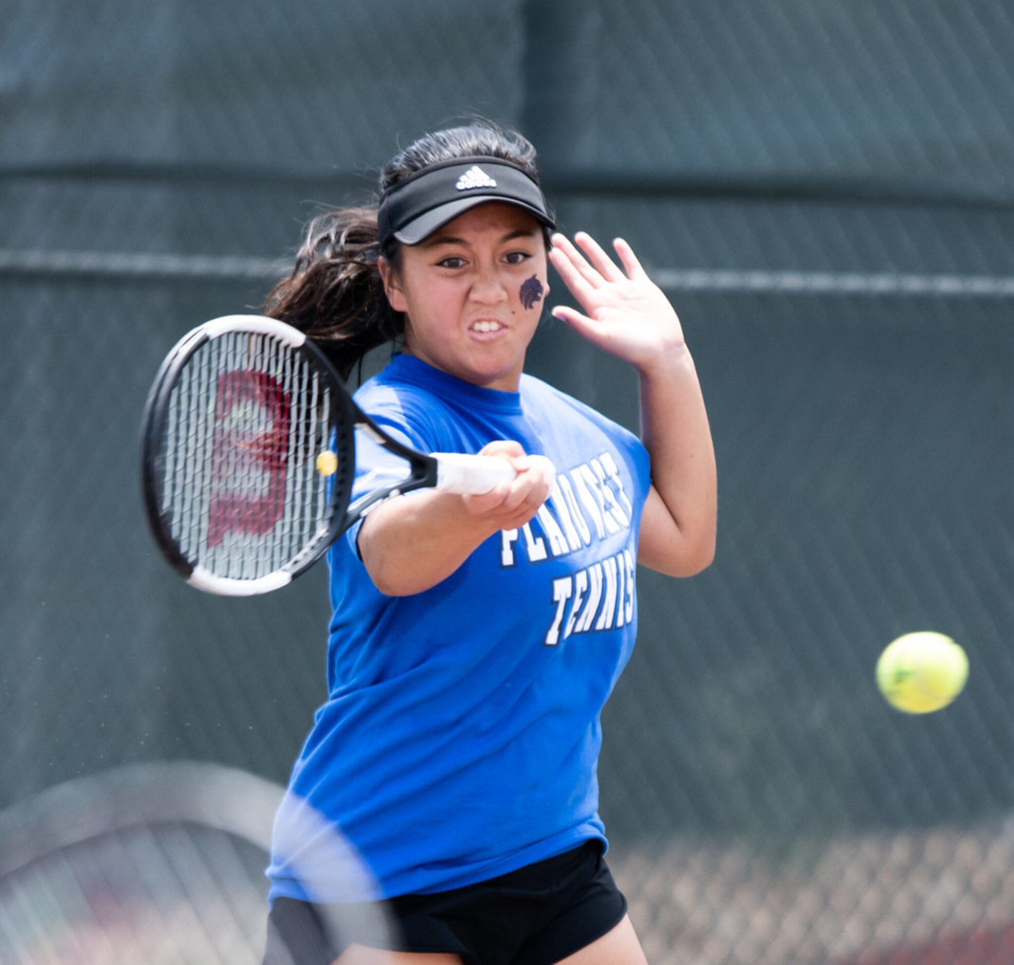 Plano West's Emma Gener returns the ball in a doubles match with teammate Caden Moortgat in...