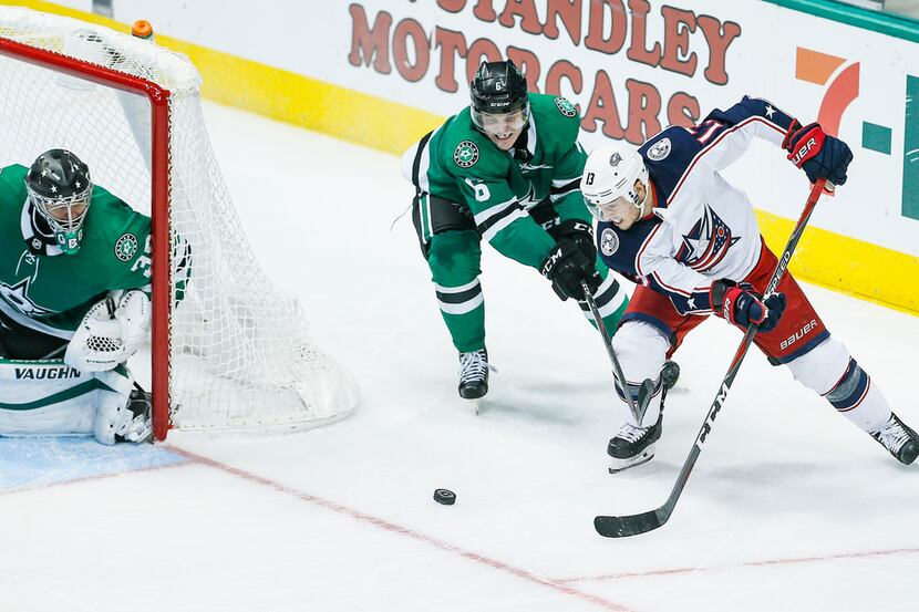 Columbus Blue Jackets forward Cam Atkinson (13) dumps the puck in front of the net as Dallas...