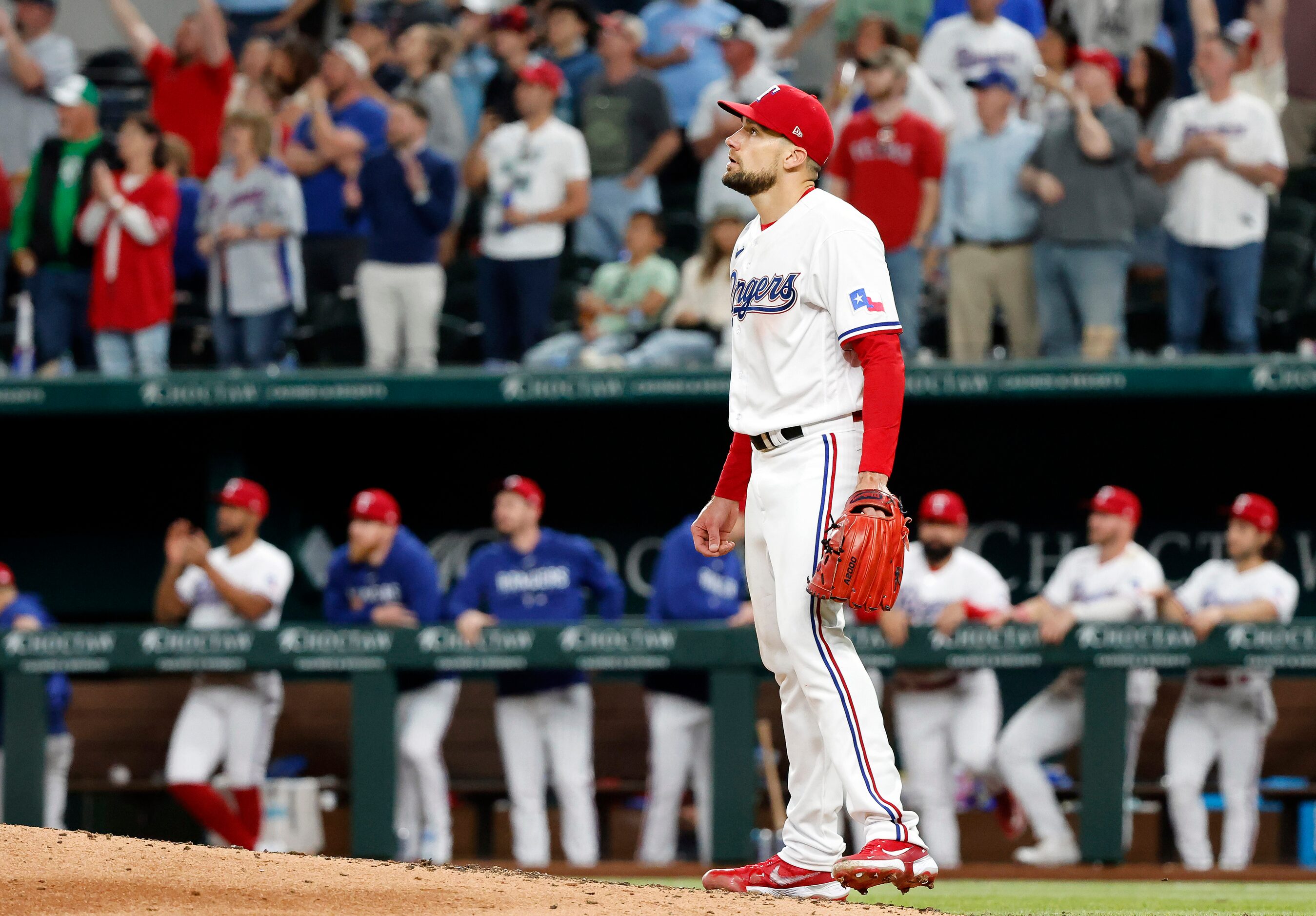 Texas Rangers starting pitcher Nathan Eovaldi (17) watches the final out of his 9-inning...