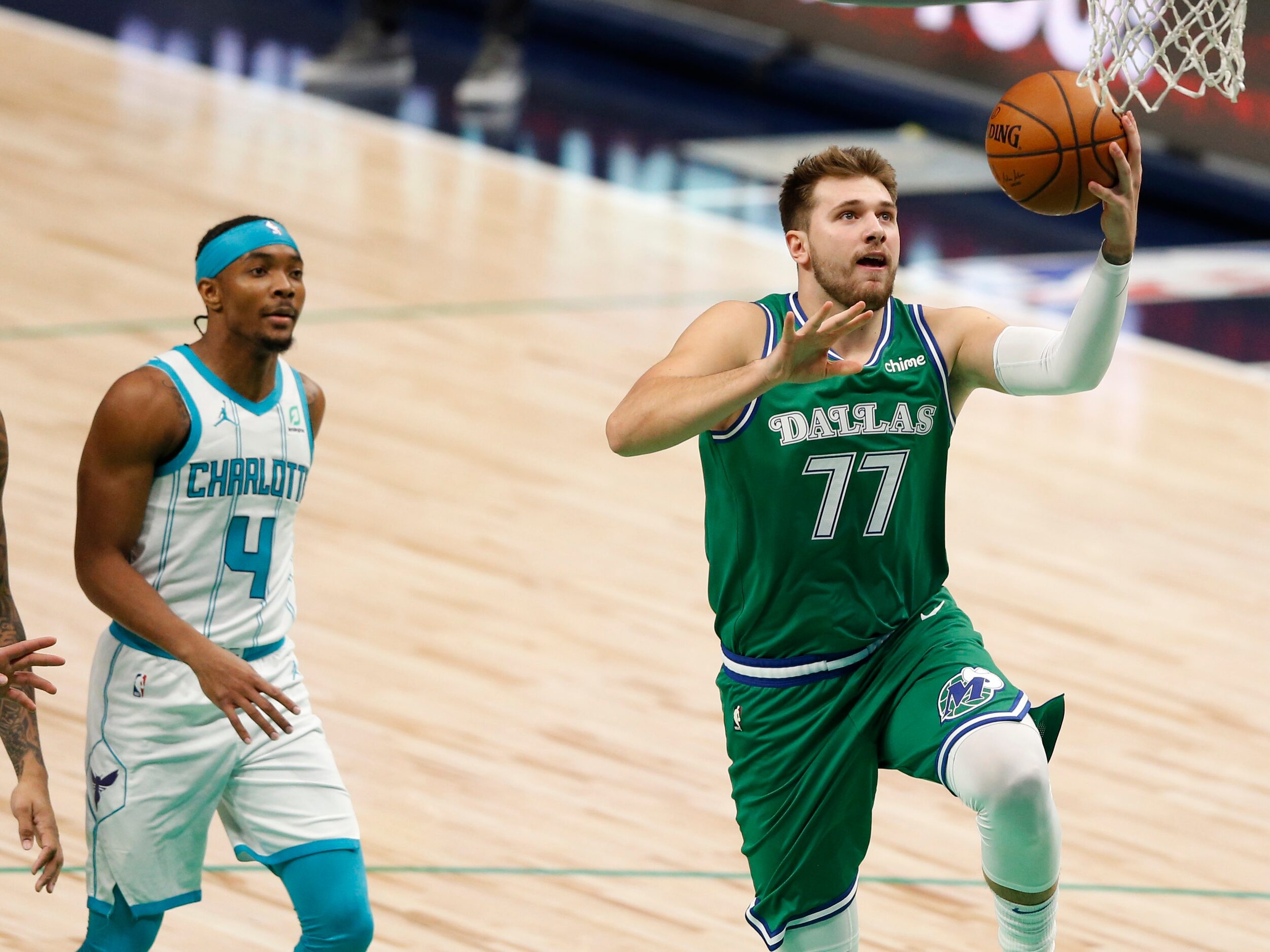 Dallas Mavericks guard Luka Doncic (77) attempts a layup in a game against the Charlotte...