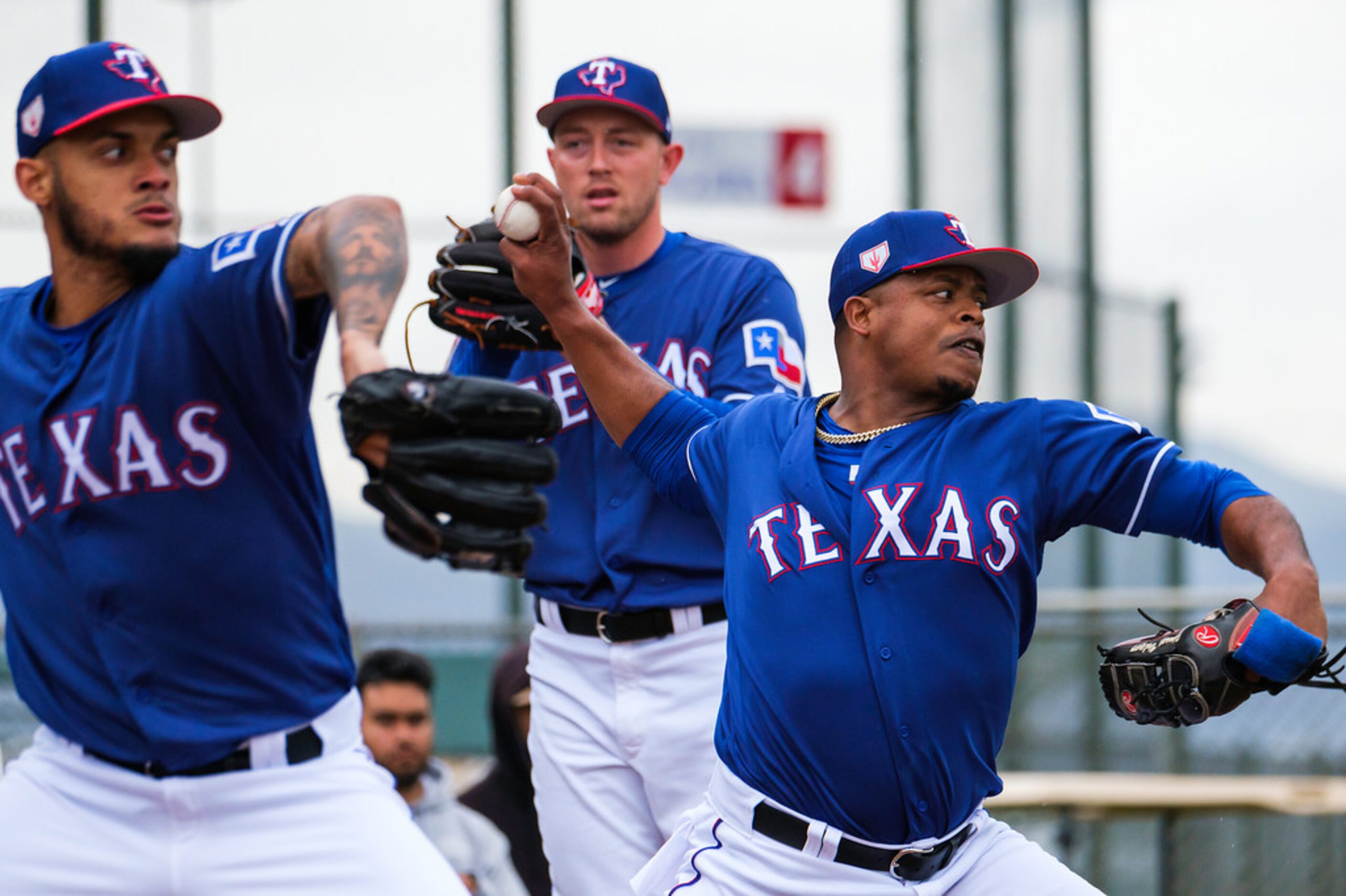 Texas Rangers pitcher Edinson Volquez (right) throws a bullpen session with Jonathan...