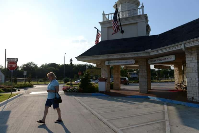 
Esther Hasselback walks out of Ben Franklin Apothecary on Main Street in Duncanville. The...