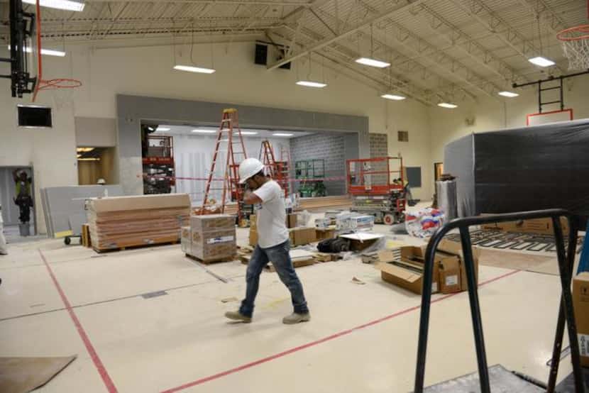 Construction workers renovate the gym at Hedgcoxe Elementary School in Plano. Hedgcoxe is...