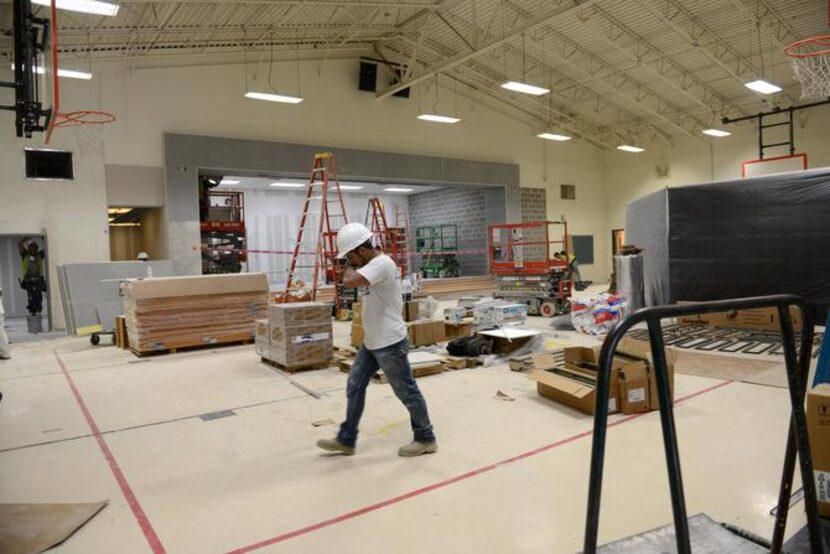 Construction workers renovate the gym at Hedgcoxe Elementary School in Plano. Hedgcoxe is...