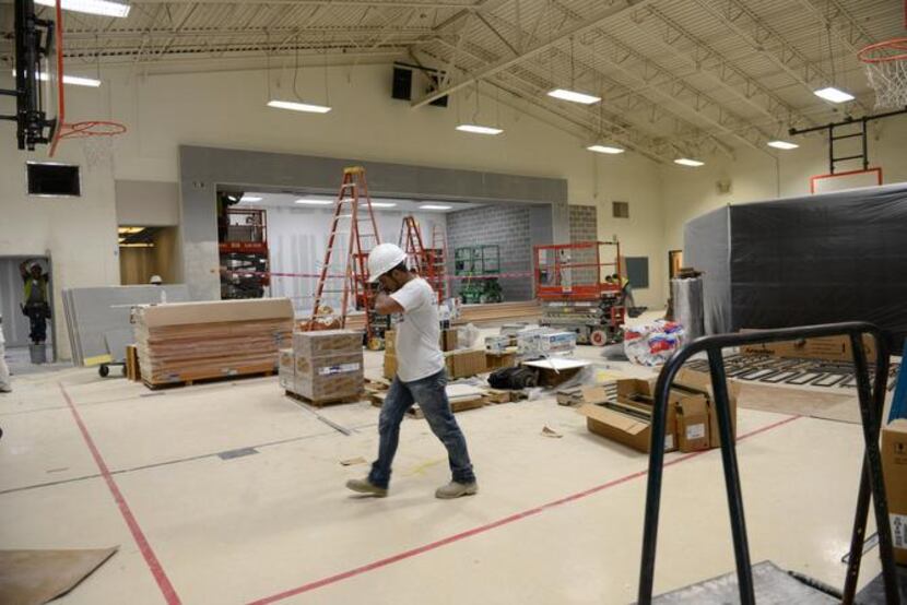 Construction workers renovate the gym at Hedgcoxe Elementary School in Plano. Hedgcoxe is...