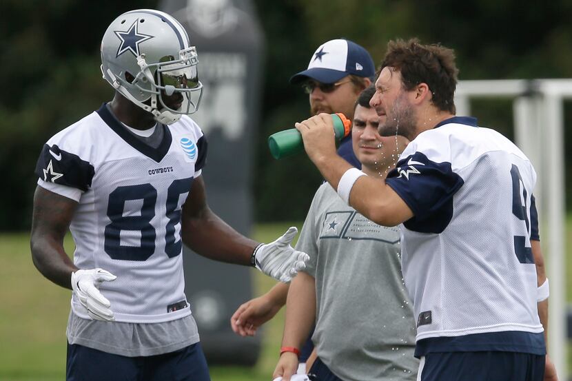 Dallas Cowboys quarterback Tony Romo (9) sprays water on his face as teammate wide receiver...