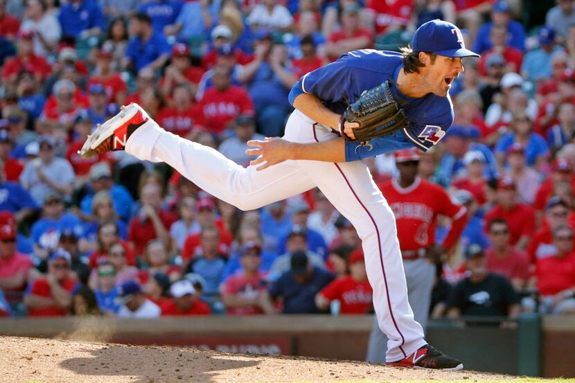 Texas Rangers starting pitcher Cole Hamels (35) throws a ninth-inning pitch in his complete...