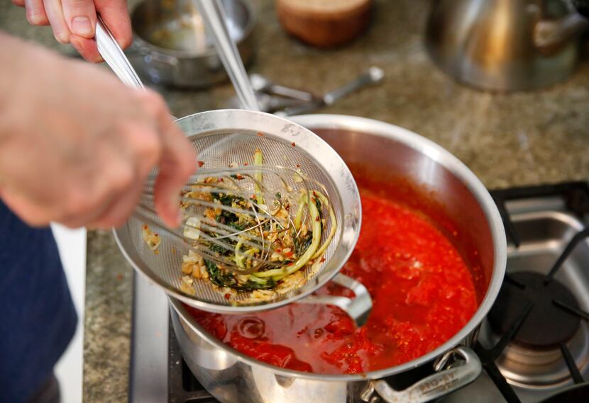 Barsotti adds olive oil infused with basil and garlic to the tomato sauce.