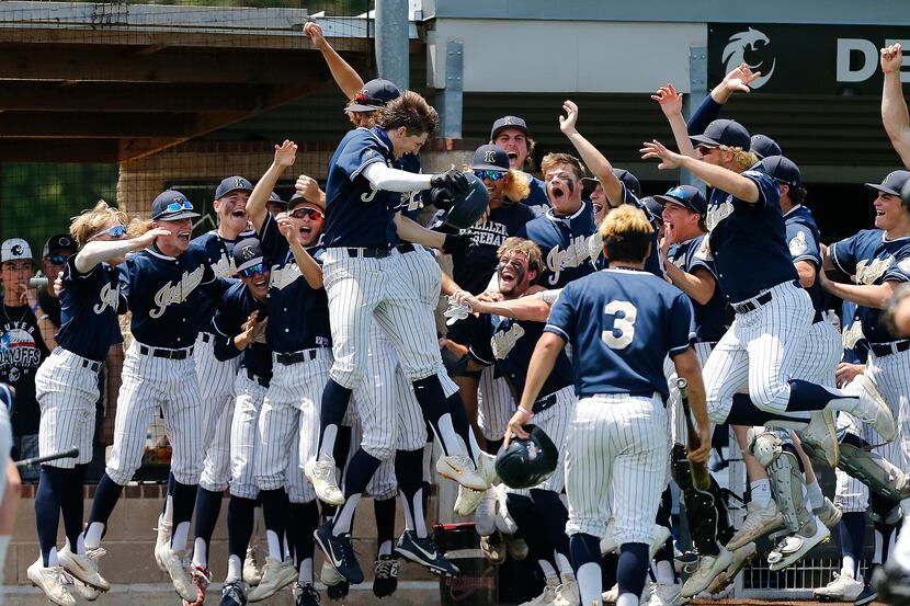 Keller right fielder Clayton Thomas (center) celebrates his home run with the team in the...