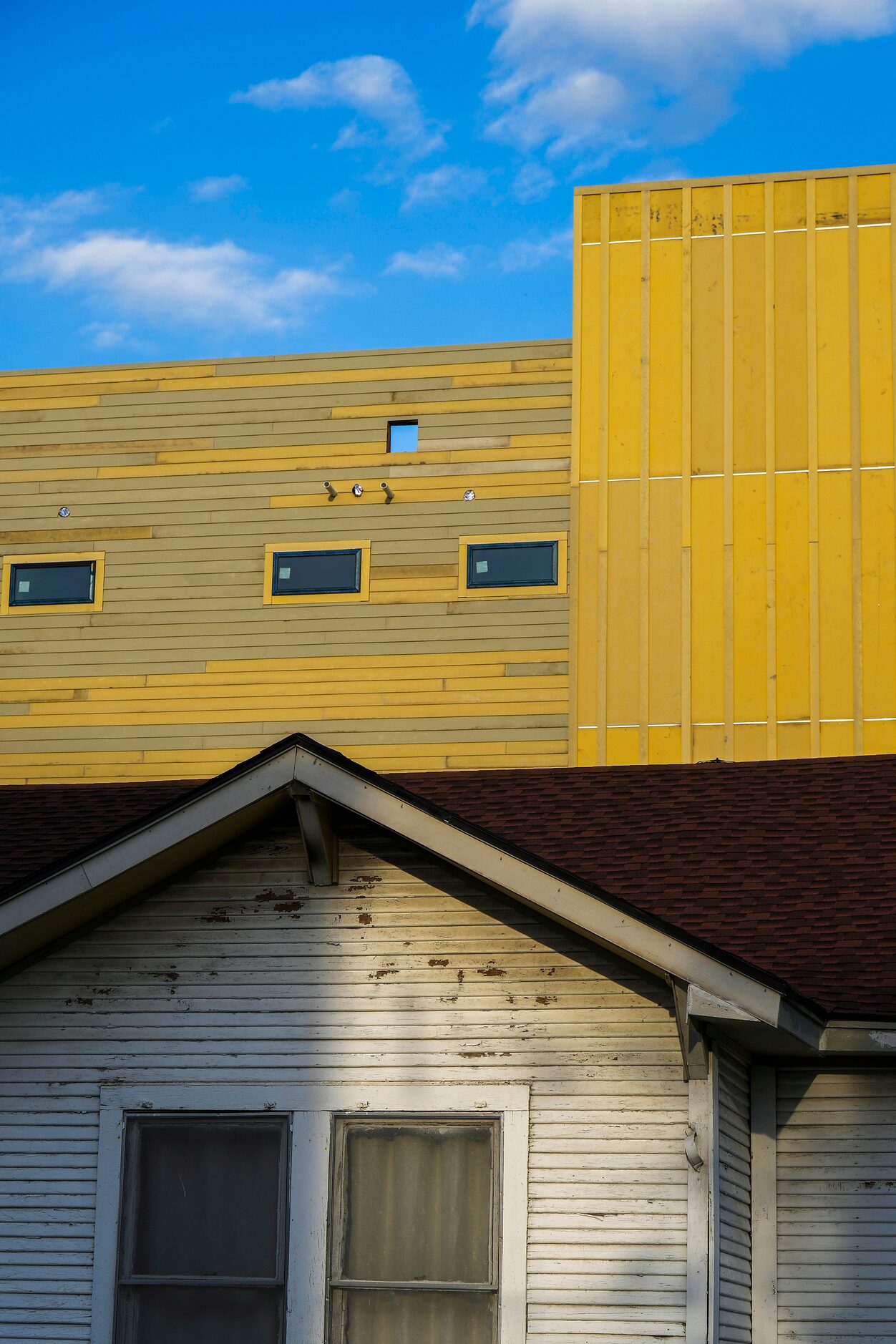 New construction towers over a home on Muncie Avenue at Crossman Avenue in the Gilbert-Emory...