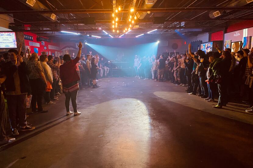 Members of the crowd follow Dan Deacon's directions during his concert at Deep Ellum Art Co....
