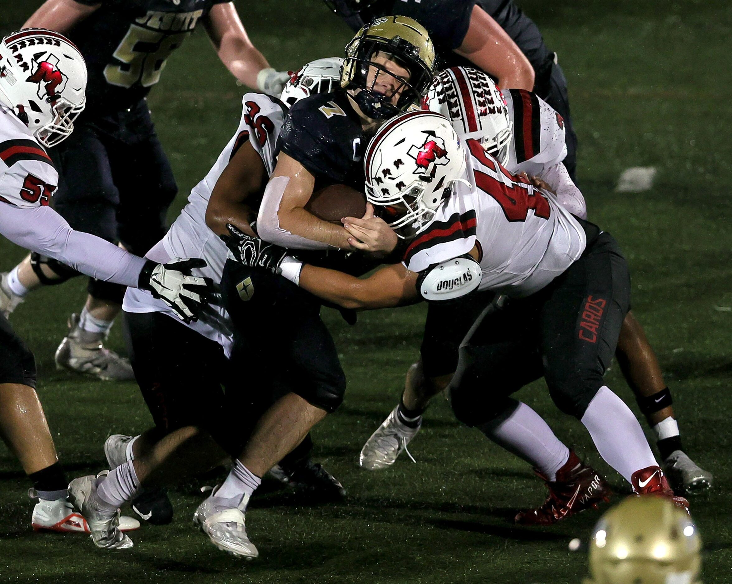 Jesuit wide receiver Jake Musso (7) is hit hard from the MacArthur defense during the first...