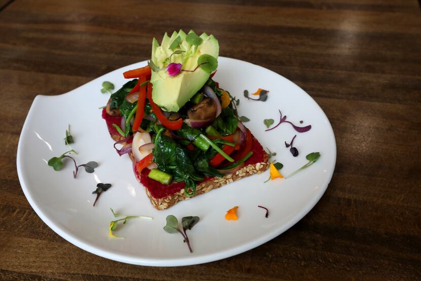 The veggie toast at Nest Cafe includes avocado, pan-seared mushrooms, spinach, asparagus,...