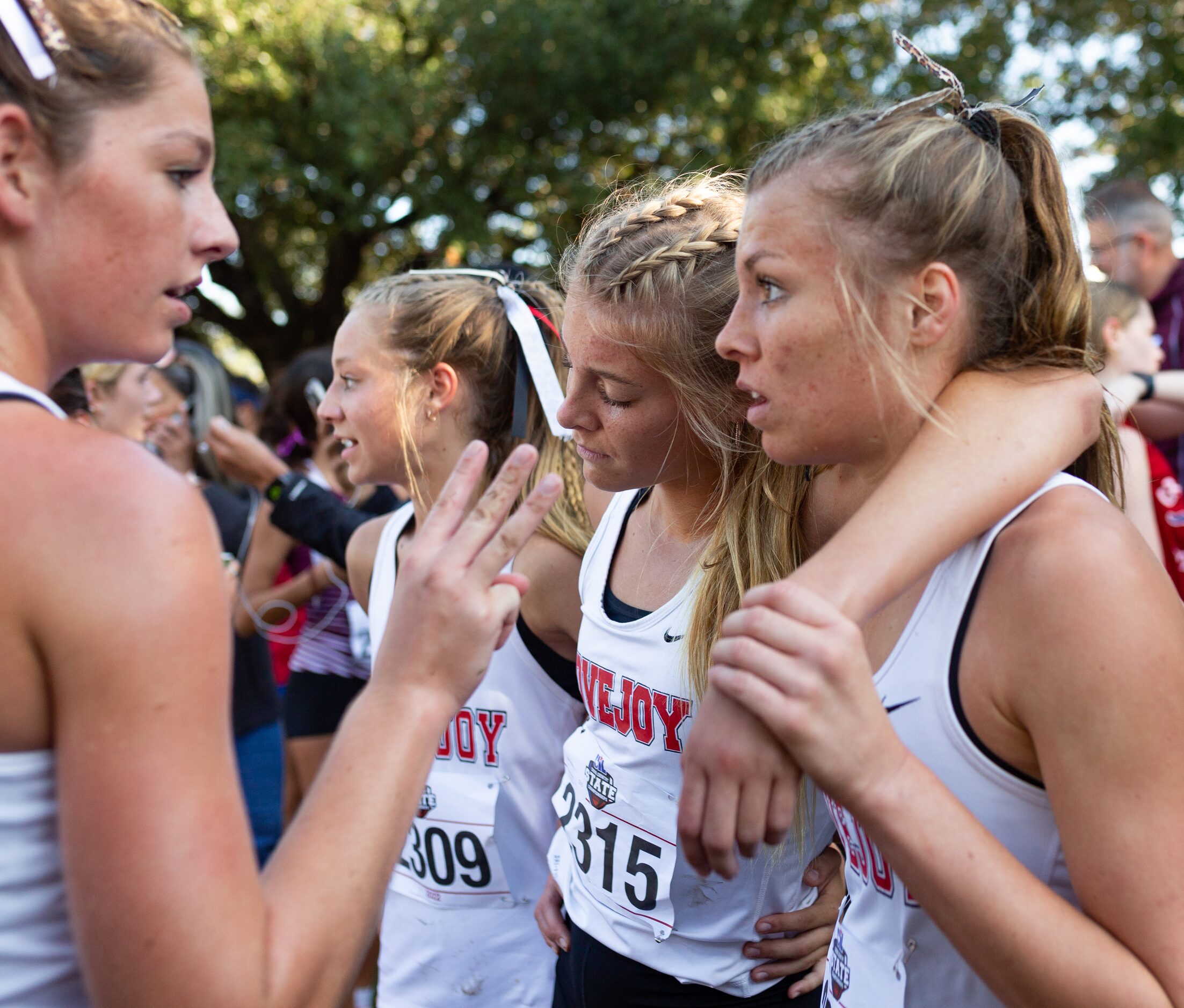 Sara Morefield of the Lovejoy Leopards leans on her older sister Amy Morefield after the 5A...