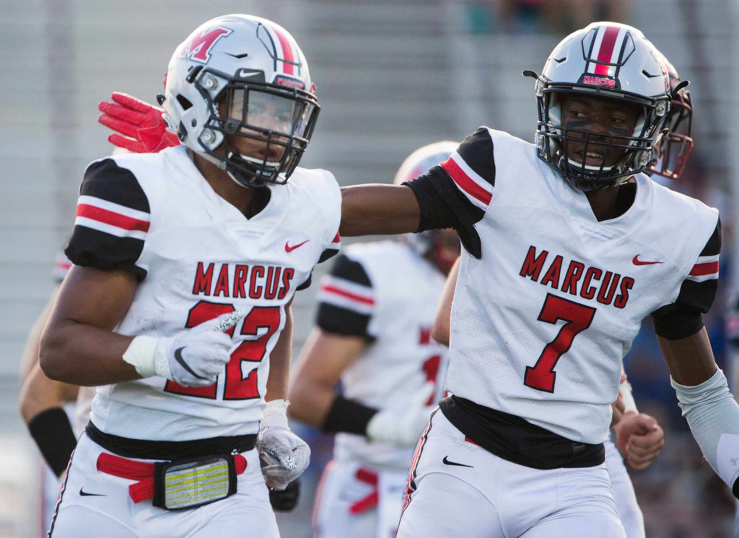 Flower Mound Marcus running back Ty'son Edwards (22) gets a pat on the back from wide...