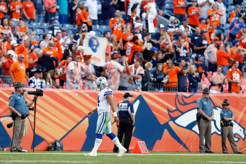 Dallas Cowboys quarterback Dak Prescott (4) walks back to the sideline after throwing an...