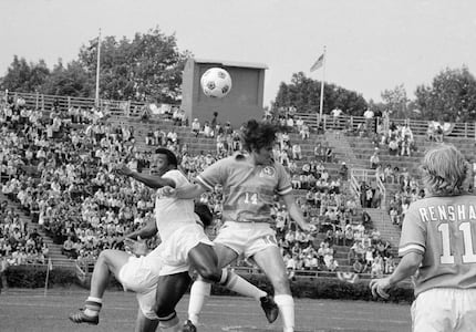 New York Cosmos soccer star Pele goes up against Dallas Tornado Bobby Moffat (14) during an...