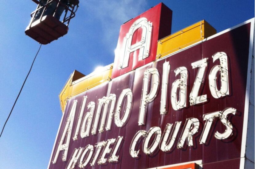 A crew began removing the iconic sign at the former site of the Alamo Plaza Hotel Courts on...