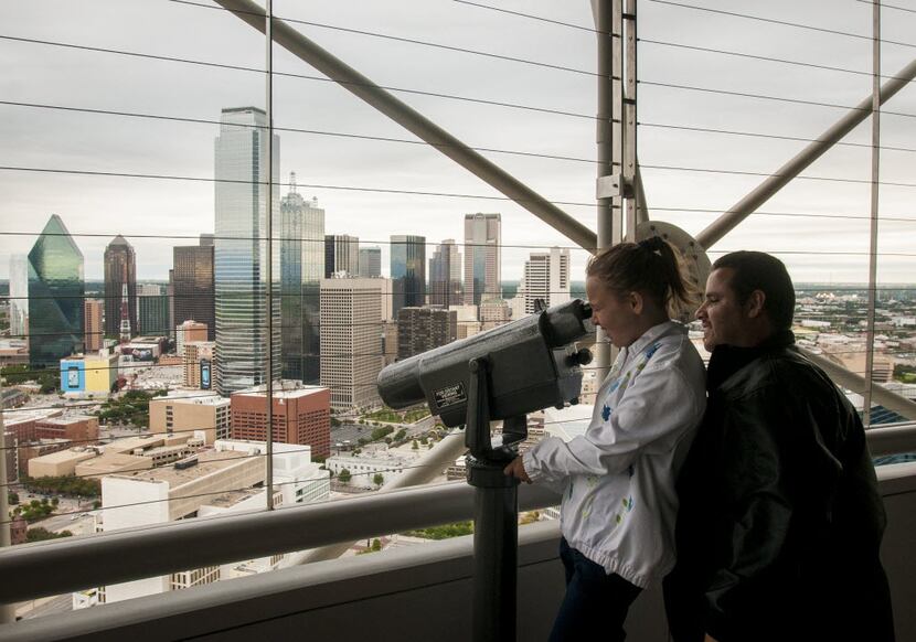 Amber Torres, 11, and her father Gilbert Torres take in the view of downtown Dallas from the...