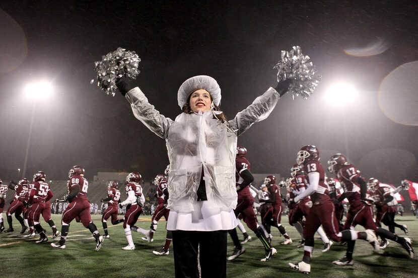 Dressed in plastic to stay a tiny bit more dry and warm, Ennis drill team member Rachel...