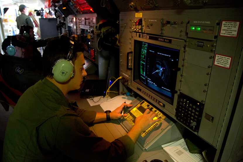 Sgt. Matthew Falanga, an airborne electronics analyst, observes a radar image aboard a Royal...