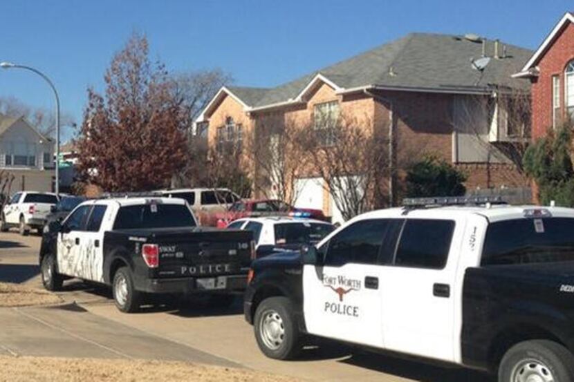 Police surround home where fatal stabbing suspect believed to be hiding.