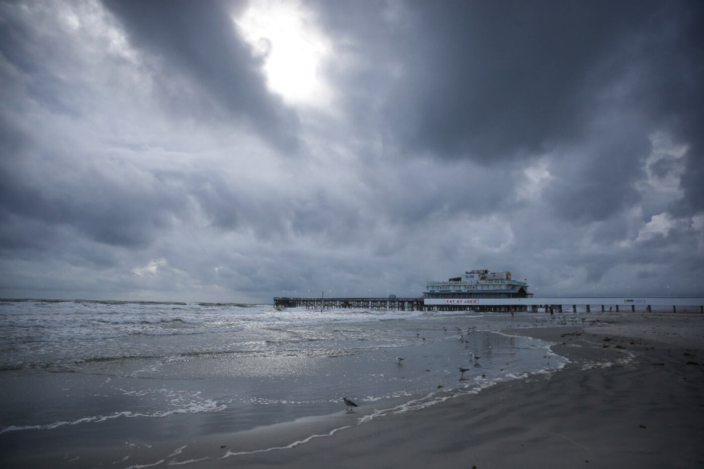 Clouds cover the sky over the beach near the Daytona Beach Boardwalk and Pier on Thursday.