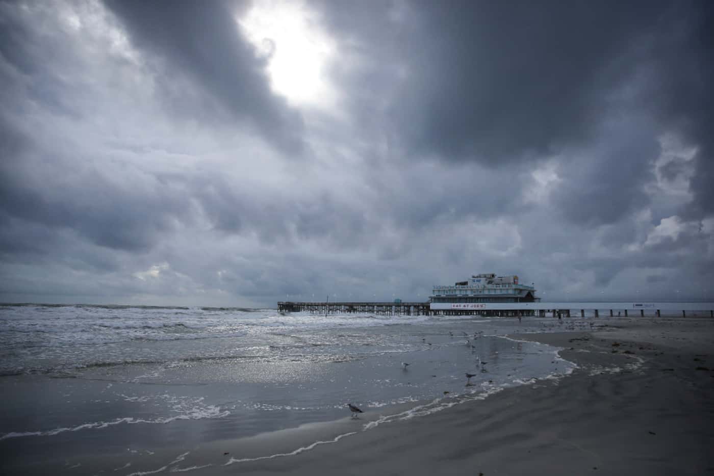 Clouds cover the sky over the beach near the Daytona Beach Boardwalk and Pier on Thursday.