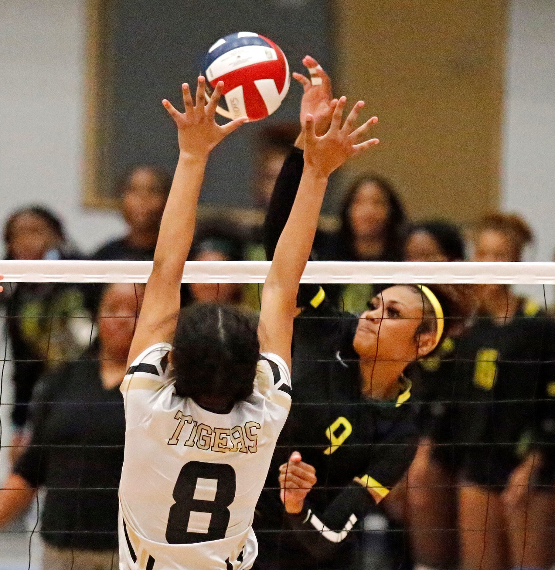 DeSoto High School outside hitter Haley Davenport (9) attempts a hit while Mansfield High...