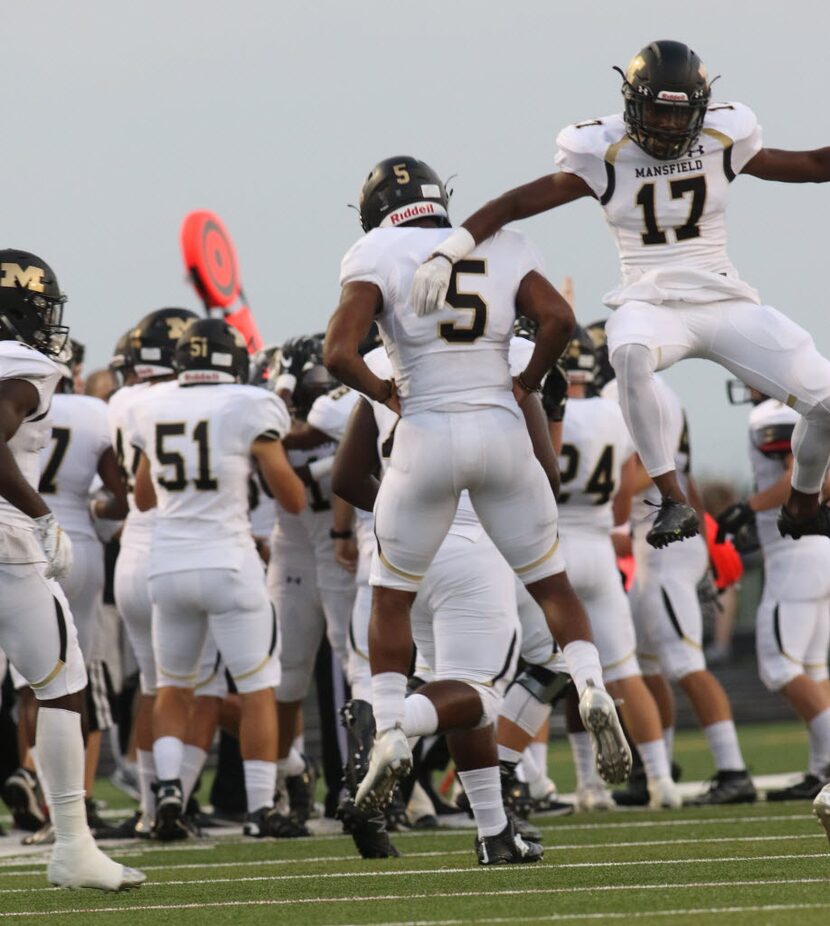 Mansfield Tigers Bram Nunn (17) and Kennedy Brooks (5) jump for joy after the special teams...