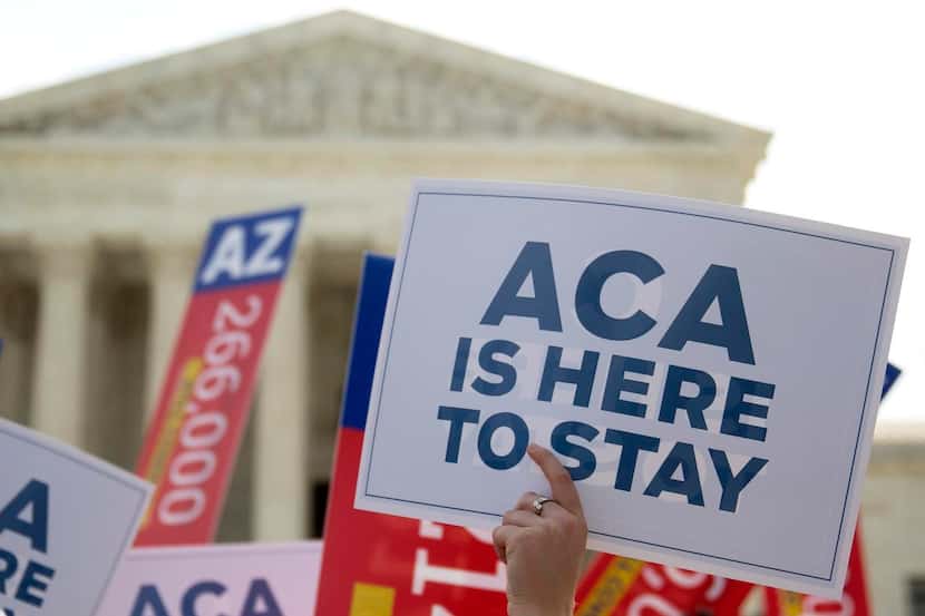 
A demonstrator, in support of  the Affordable Care Act, holds up a  sign after the U.S....