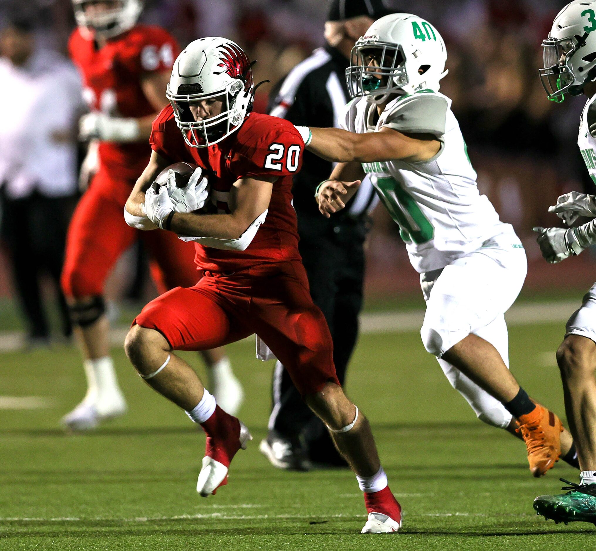 Argyle running back Landon Farris (20) tries to fight his way for yardage against Lake...