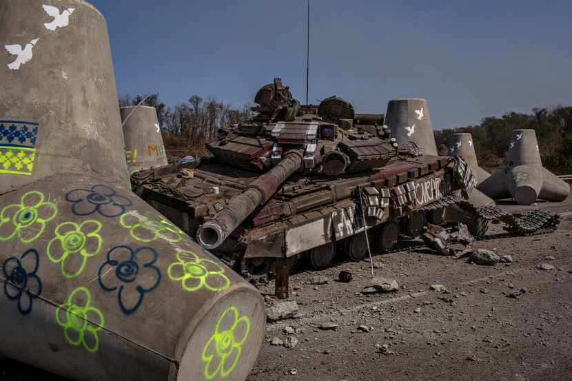 A destroyed Ukrainian army tank sits amid concrete fortifications in Shirokine, a village...