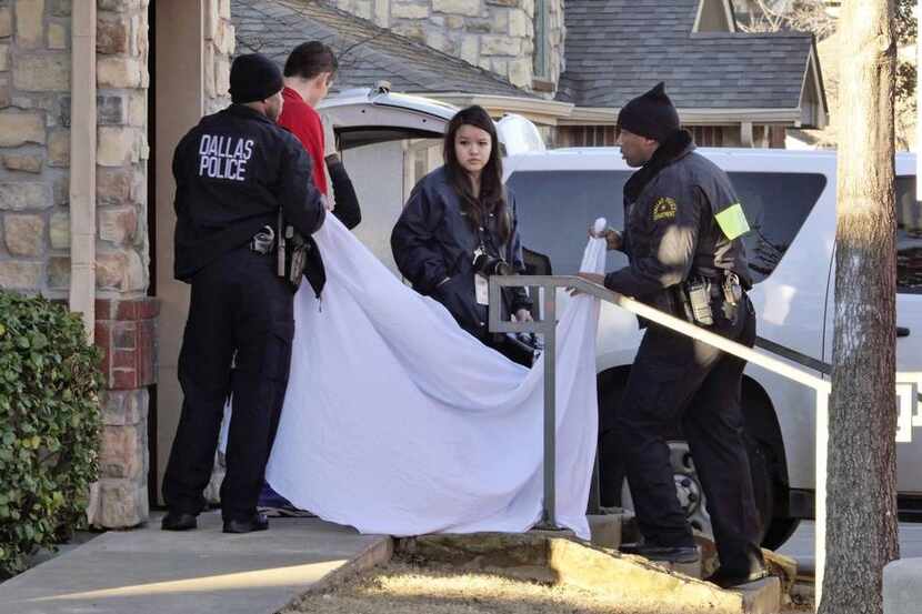 Dallas police officers used a sheet to cover the doorway as 2-month-old Justice Hull was...