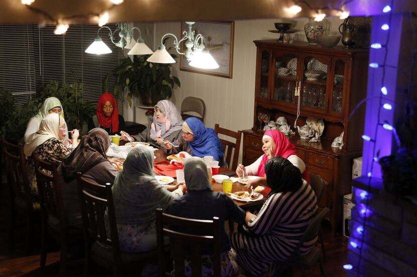 Muslim women wearing hijab break fast during an iftar dinner in Arlington in 2014. (Brad...