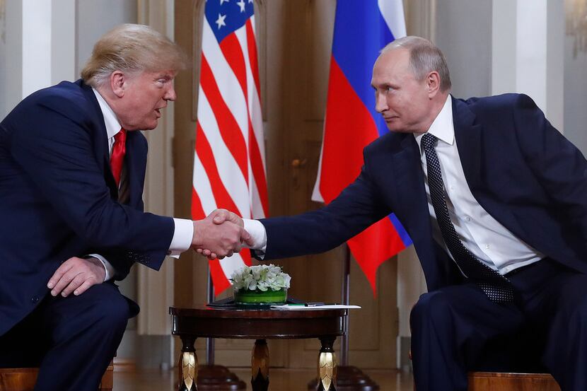 The real U.S. president, Donald Trump (left), shakes hands with Russian President Vladimir...