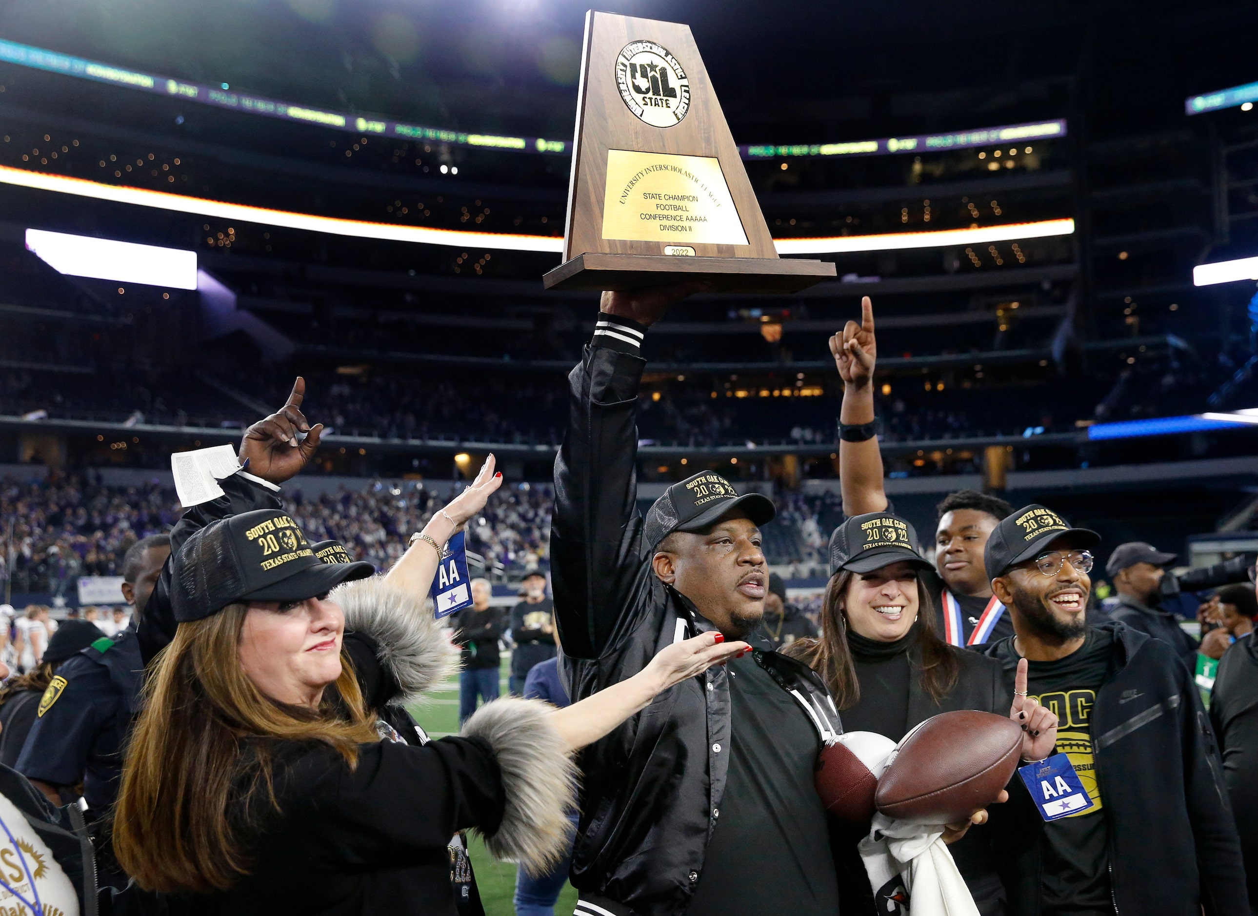 South Oak Cliff head coach Clifton Todd hoists the Class 5A Division II state football...