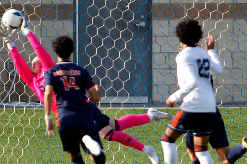 Sachse goalkeeper Josh Weston (00) makes a diving save just inside the corner of the goal...