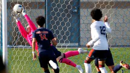 Sachse goalkeeper Josh Weston (00) makes a diving save just inside the corner of the goal...
