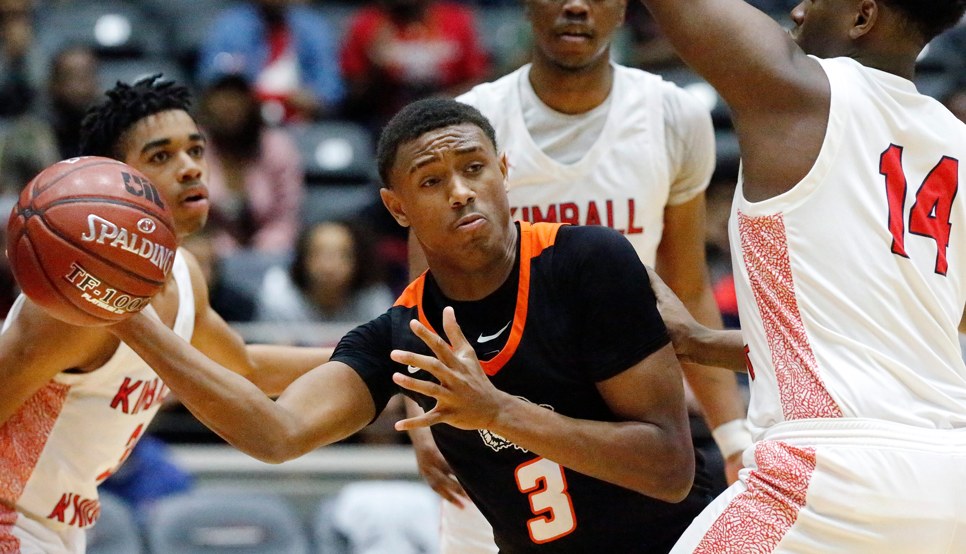 Lancaster High School guard Markies Sykes (3) passes the ball around Kimball High School...