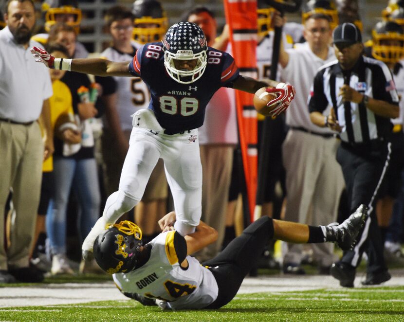 Ryan wide receiver Chritauskie Dove (88) trys to break loose from the leg tackle of Cade...