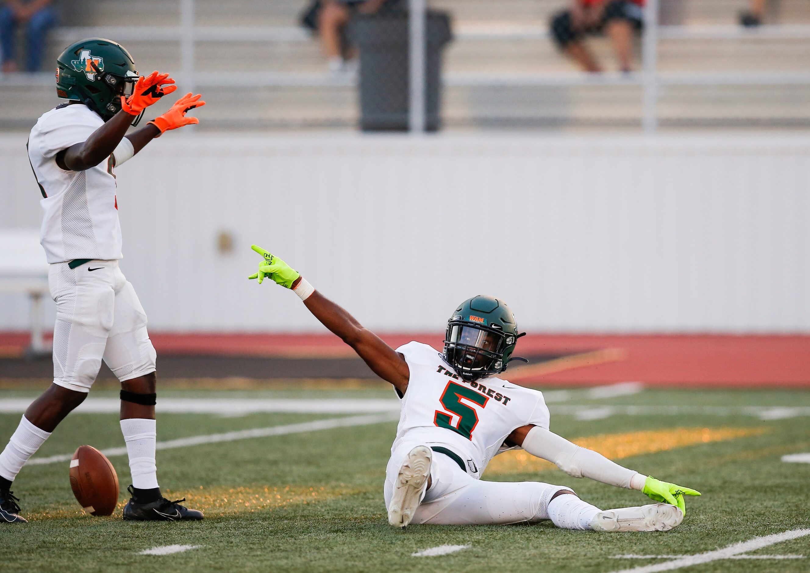 Garland Naaman Forest junior defensive back Lamont Potts, left, celebrates with senior...